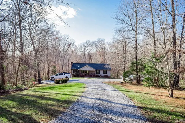 a front view of a house with a yard and sitting area