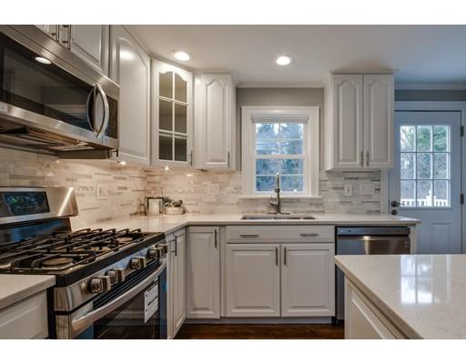 a kitchen with stainless steel appliances a sink stove and microwave