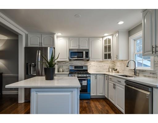 118 Concord Road Wayland, MA 01778 - Photo 5 of 28 a kitchen with a sink a microwave a refrigerator and cabinets
