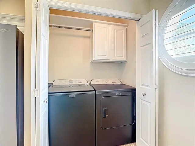 a view of a room with a ceiling fan wooden floor and a ceiling fan