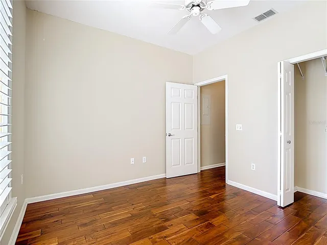 a bathroom with a granite countertop sink toilet mirror and bathtub