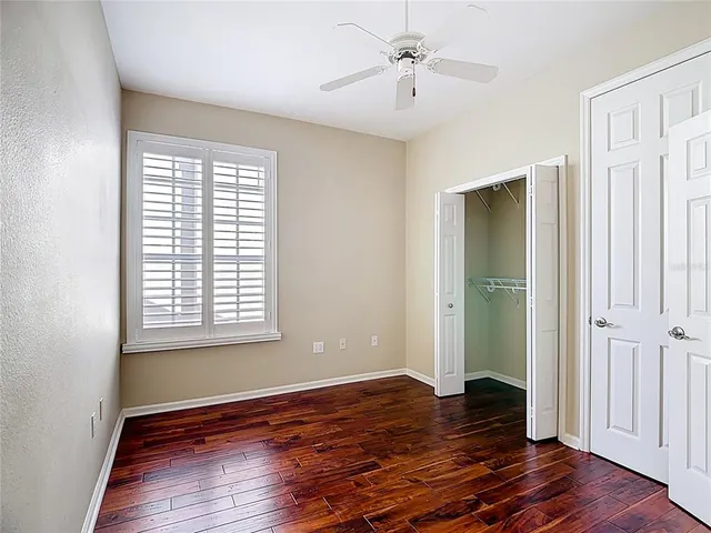 a view of a room with wooden floor and windows