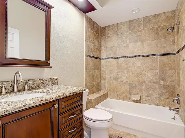 an aerial view of ocean and residential houses with outdoor space