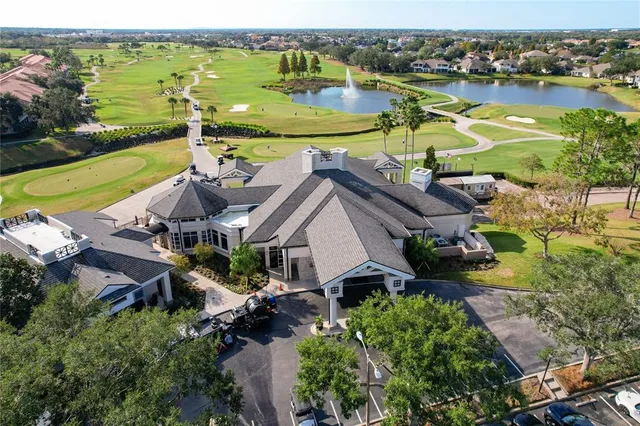 an aerial view of a house with a yard and lake view