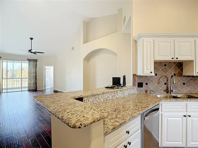 a kitchen with cabinets stainless steel appliances and a sink