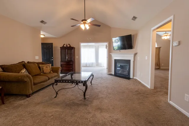 a living room with furniture and a fireplace