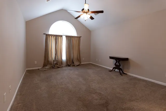 a view of an empty room with a window