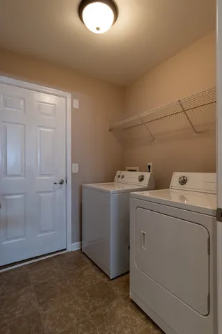 a view of storage and utility room with washer and dryer