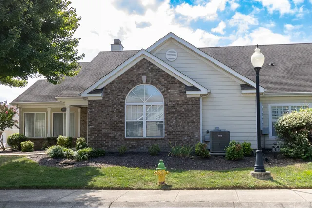 a front view of a house with a yard and a garage