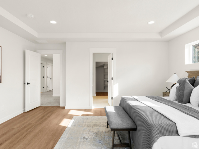 1711 West Canyon Rim Road North Lehi, UT 84048 - Photo 13 of 31 Recessed lighting illuminates a spacious room featuring crown molding, white paneled doors with black hardware, and wood-finish flooring