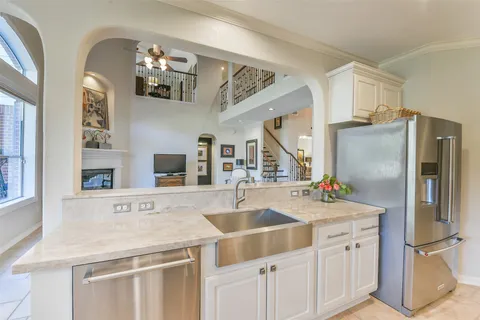 a kitchen with stainless steel appliances a sink and a refrigerator