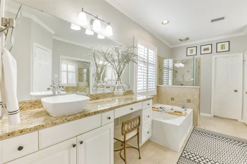 a large spacious bathroom with a granite countertop sink mirror and bathtub