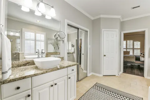 a bathroom with a granite countertop sink a mirror and a shower