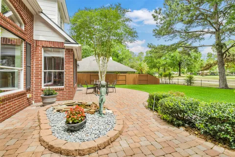 a view of a house with backyard and sitting area