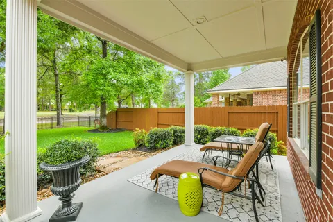 a view of a patio with table and chairs and potted plants