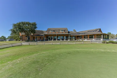 a front view of house with yard space and and car parked