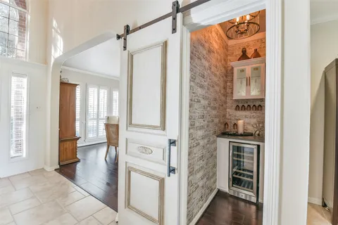 a view of a hallway with wooden floor and entryway
