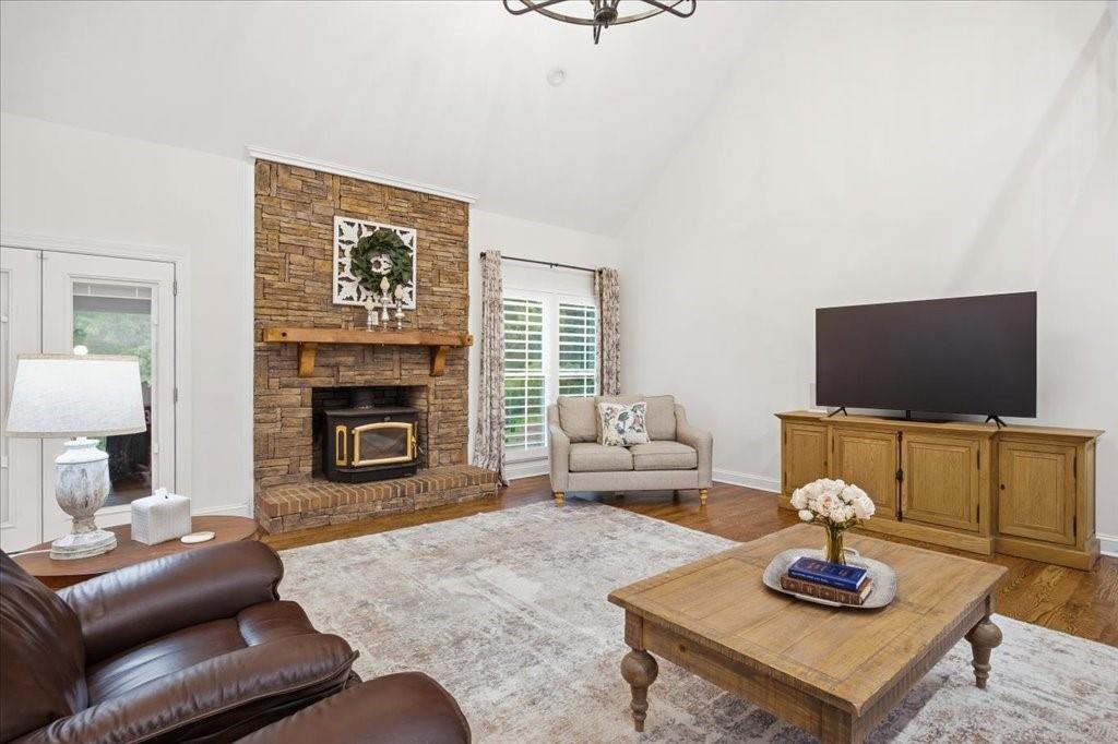397 Thomas Road Dallas, GA 30132 - Photo 17 of 108 a living room with furniture a flat screen tv and a fireplace