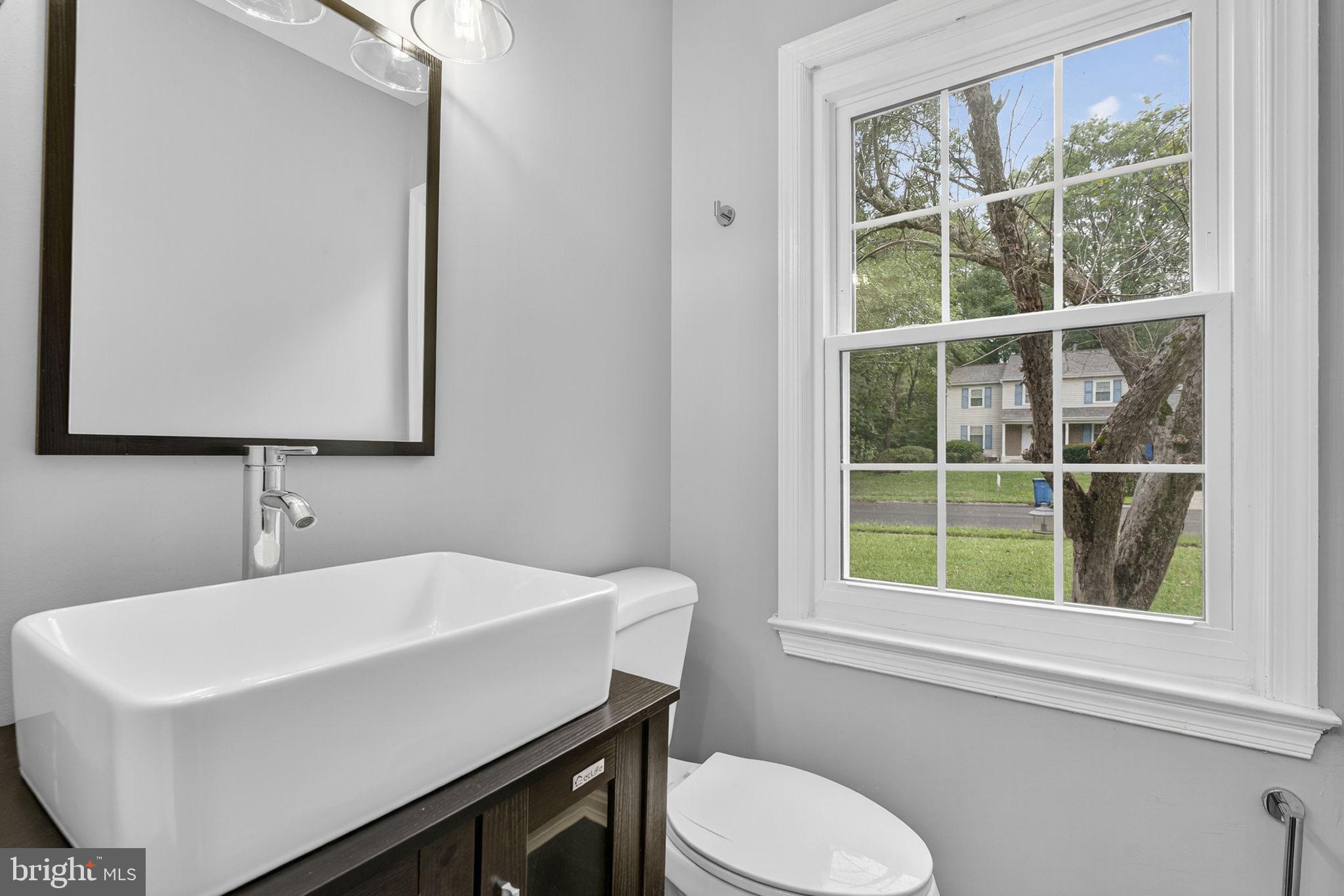 7009 Cold Spring Lane Alexandria, VA 22306 - Photo 11 of 30 a bathroom with a sink a toilet and a mirror