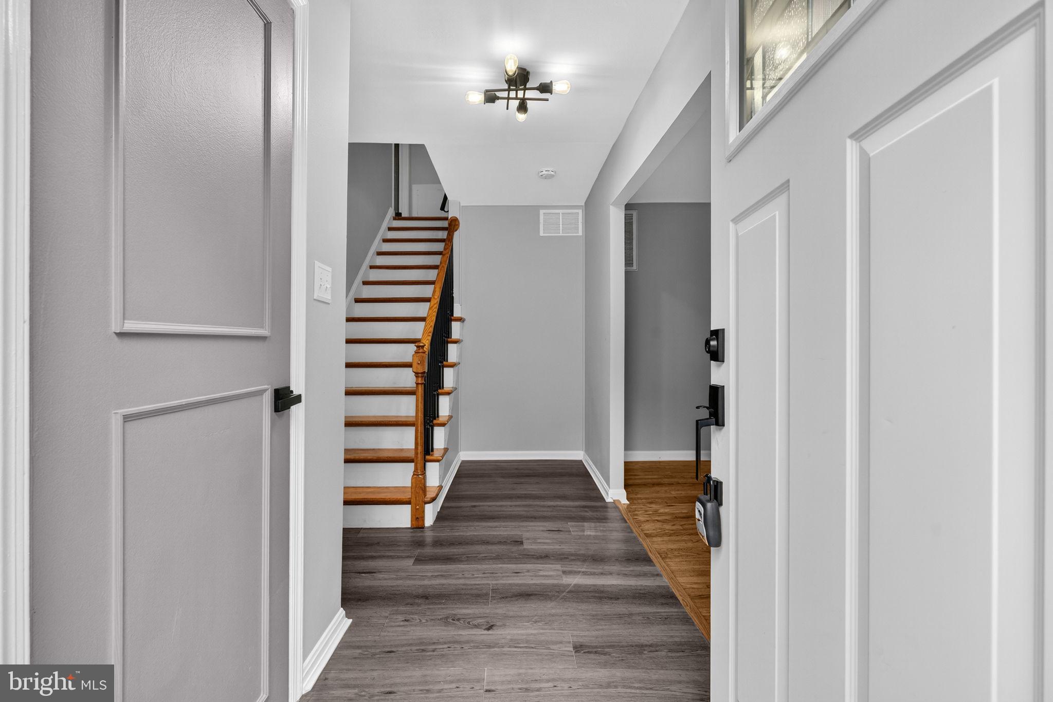 7009 Cold Spring Lane Alexandria, VA 22306 - Photo 2 of 30 a view of a hallway with wooden floor and staircase