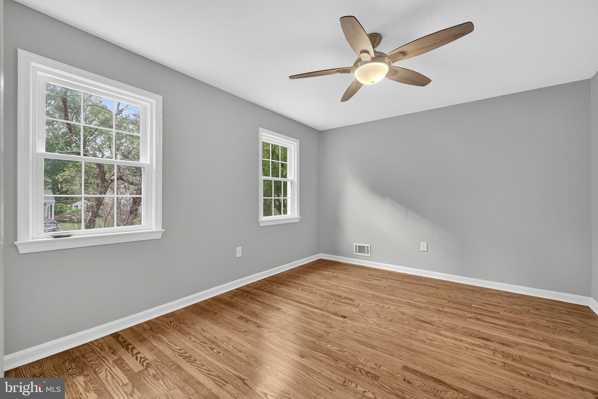 7009 Cold Spring Lane Alexandria, VA 22306 - Photo 21 of 30 an empty room with wooden floor and windows