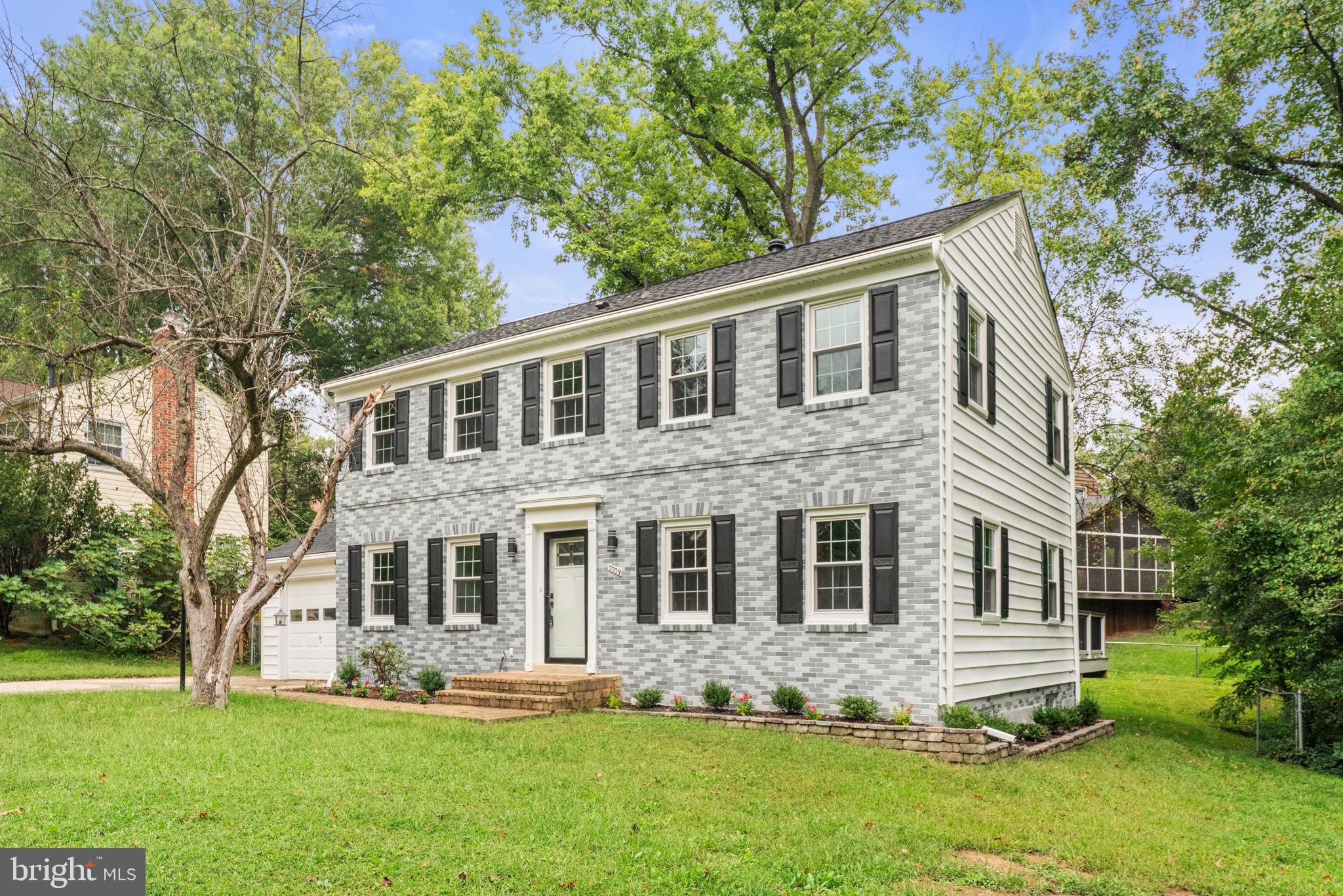 7009 Cold Spring Lane Alexandria, VA 22306 - Photo 25 of 30 a front view of a house with a yard and trees