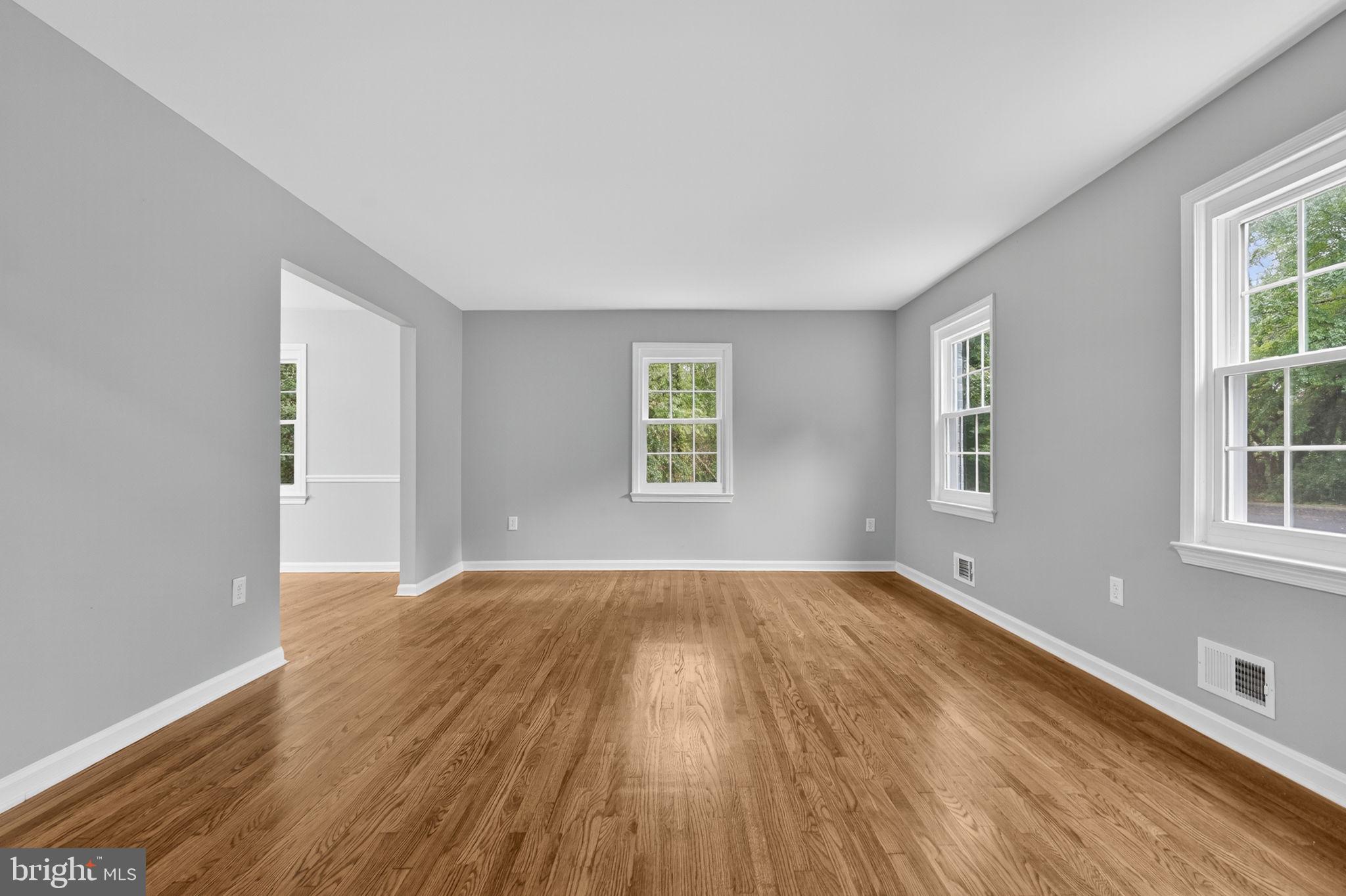 7009 Cold Spring Lane Alexandria, VA 22306 - Photo 3 of 30 a view of an empty room with wooden floor and a window