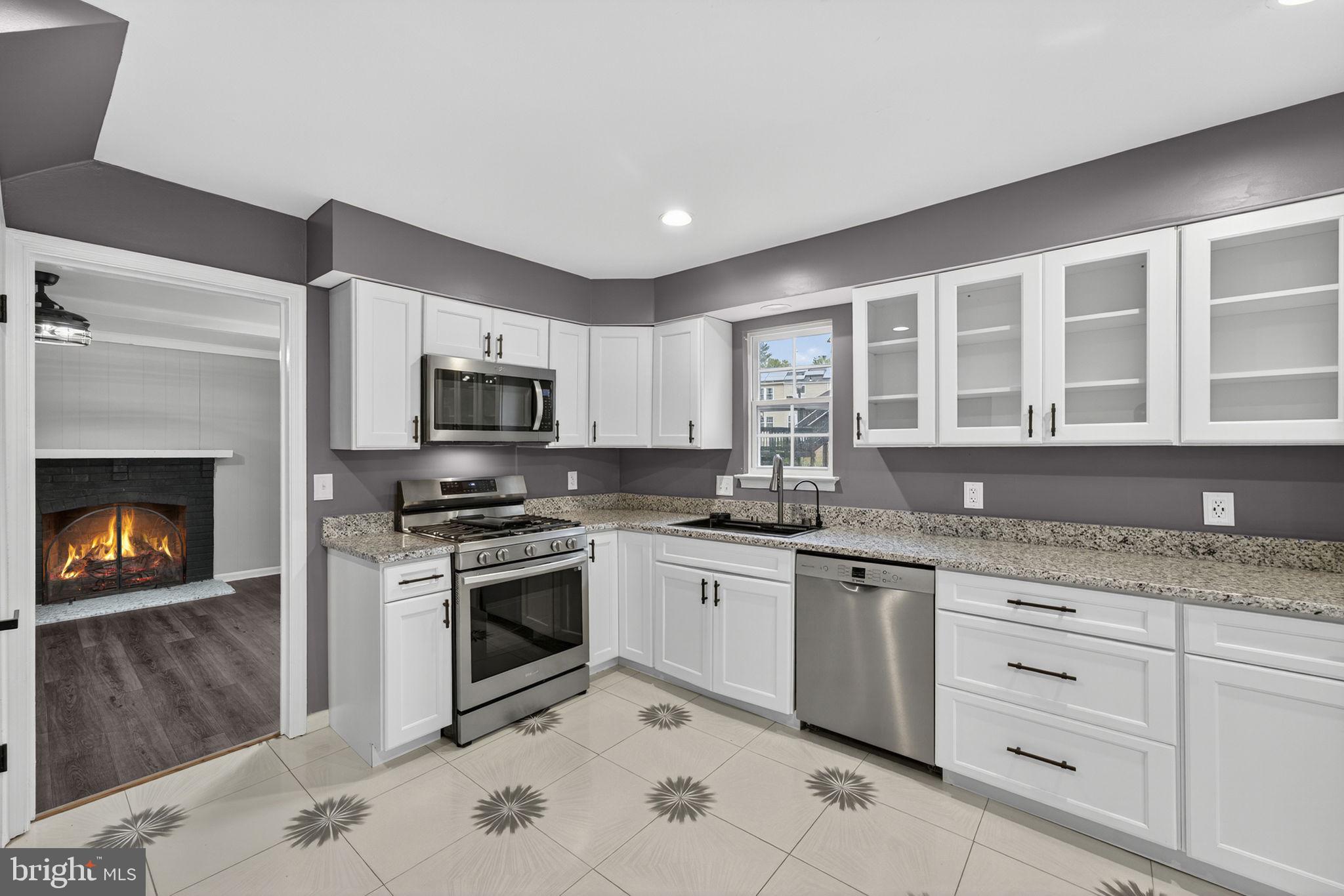 7009 Cold Spring Lane Alexandria, VA 22306 - Photo 7 of 30 a kitchen with granite countertop a sink stainless steel appliances and cabinets