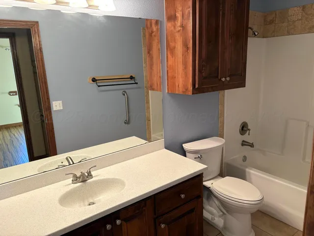 a bathroom with a sink toilet and a mirror
