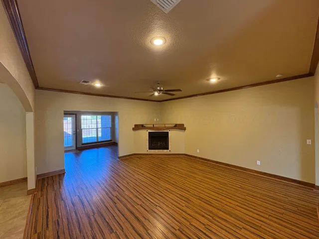 a view of a livingroom with wooden floor and window