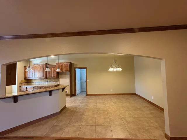 a view of a big room with wooden floor and windows