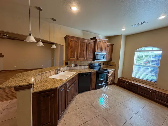 a kitchen with a sink stove and refrigerator
