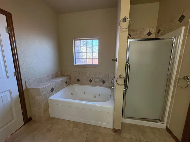 a bathroom with a bathtub and shower