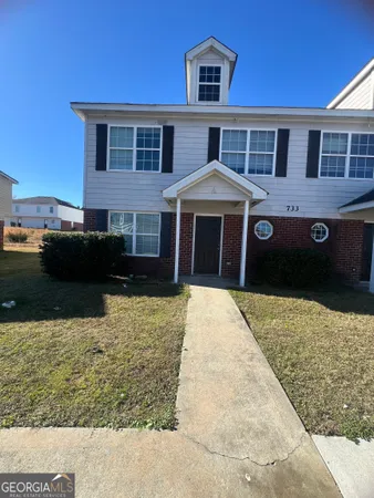 a front view of a house with a yard