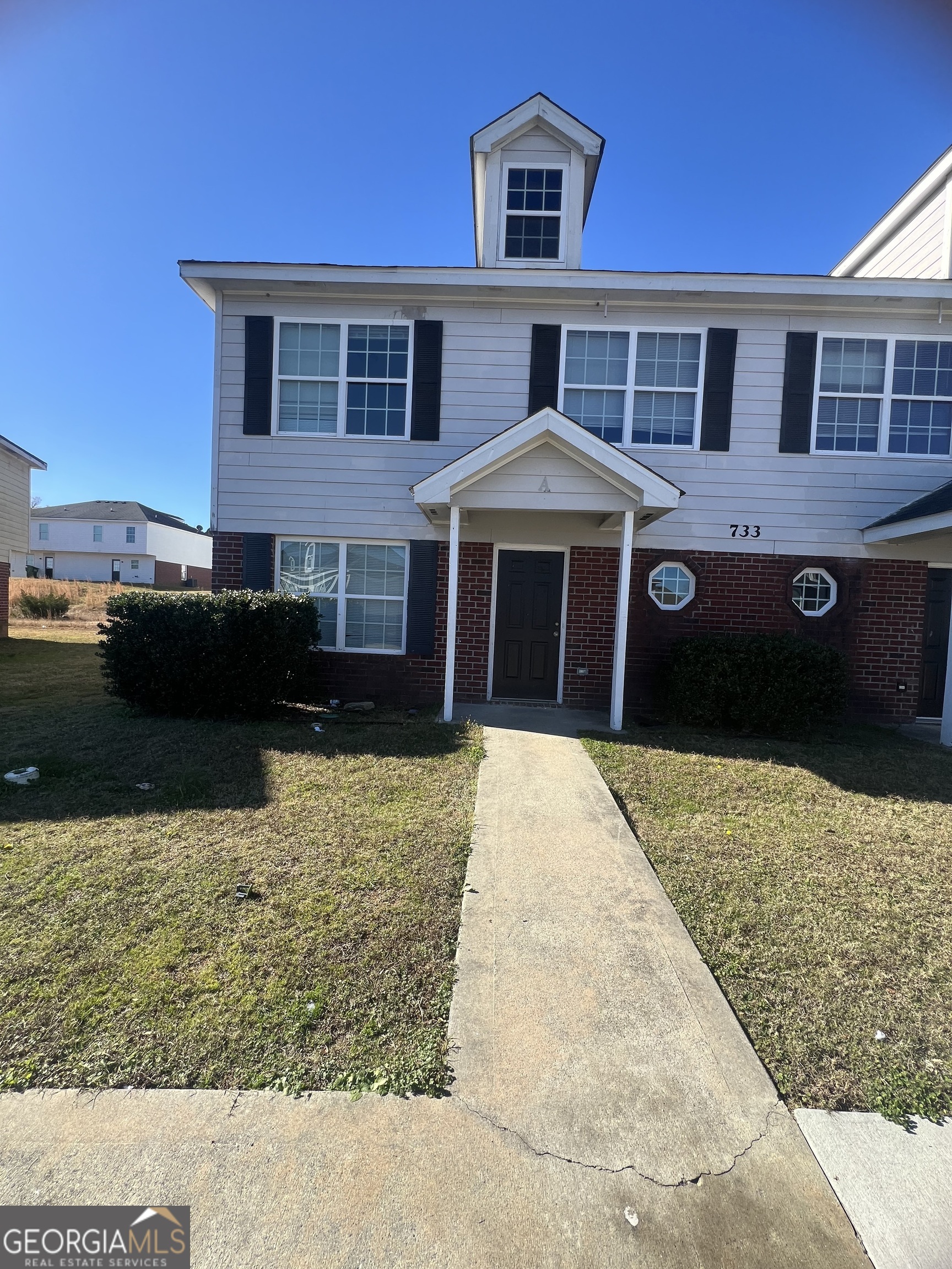 a front view of a house with a yard