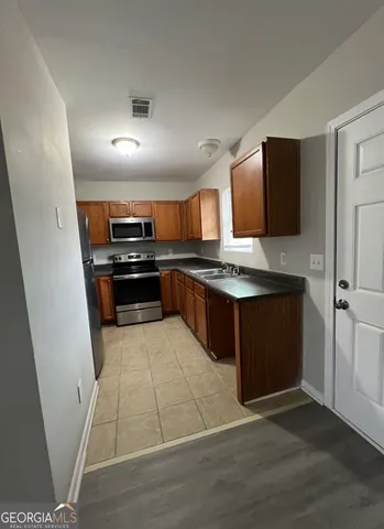 a kitchen with stainless steel appliances granite countertop a stove and a refrigerator
