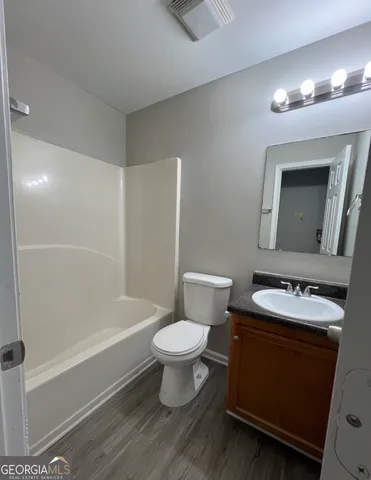 a bathroom with a sink toilet vanity and shower