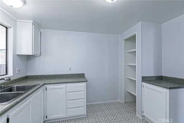 a kitchen with a sink and cabinets