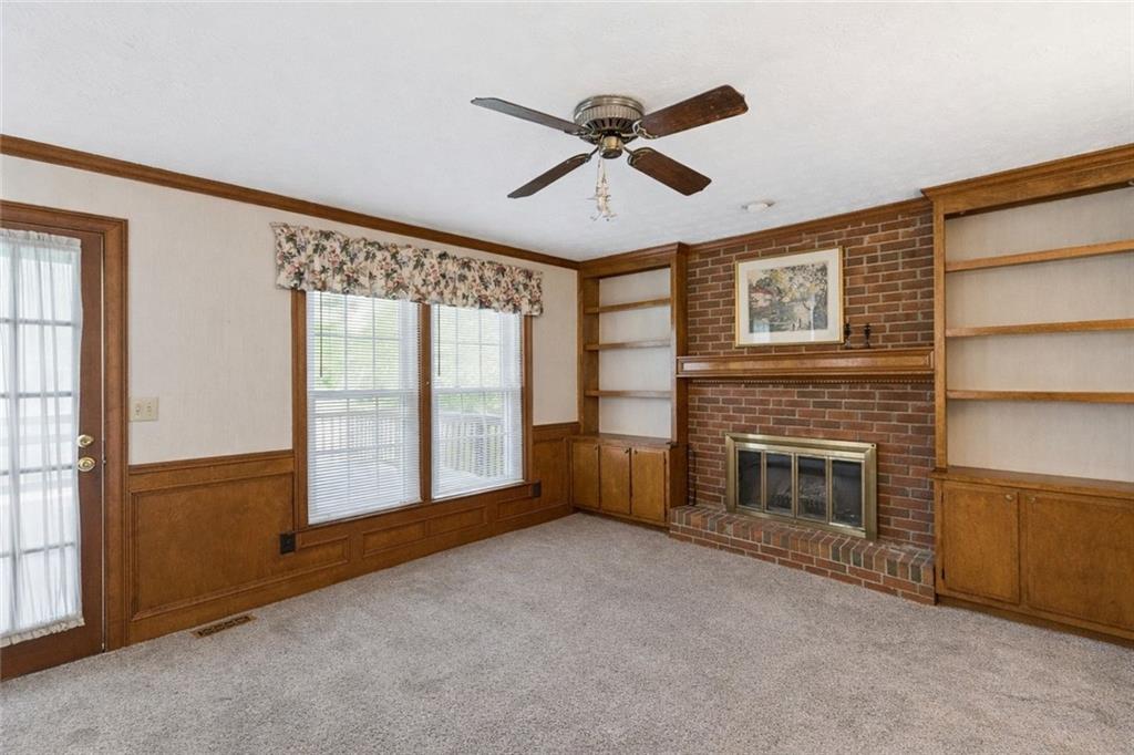 2931 Winding Circle Southwest Lilburn, GA 30047 - Photo 15 of 47 a view of an empty room with a fireplace and a window