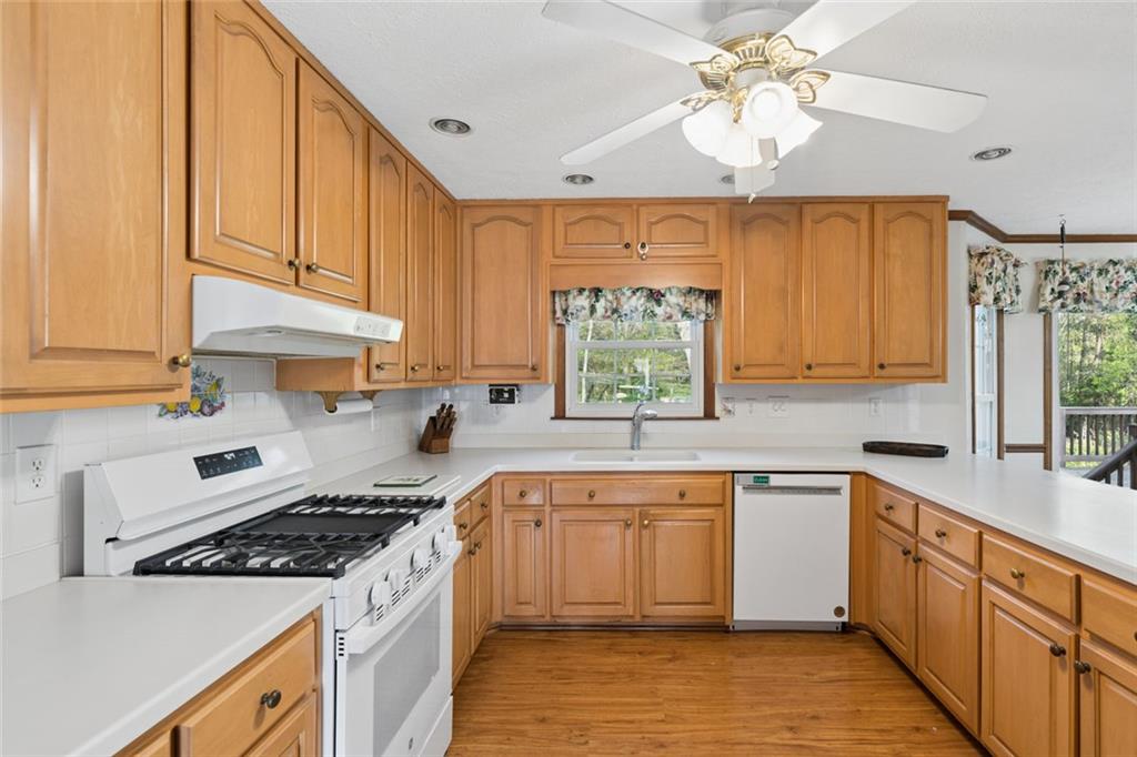 2931 Winding Circle Southwest Lilburn, GA 30047 - Photo 19 of 47 a kitchen with a sink stove and cabinets