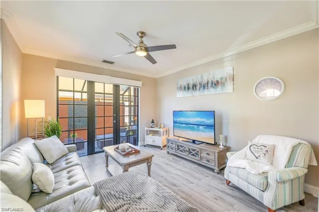 a living room with furniture and a floor to ceiling window