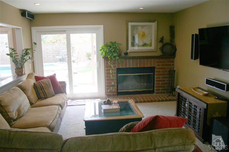 4218 Roxbury Street Simi Valley, CA 93063 - Photo 11 of 30 a living room with furniture a flat screen tv and a fireplace