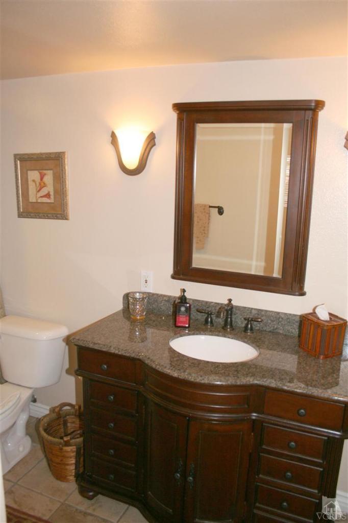 4218 Roxbury Street Simi Valley, CA 93063 - Photo 13 of 30 a bathroom with a granite countertop sink a mirror and a