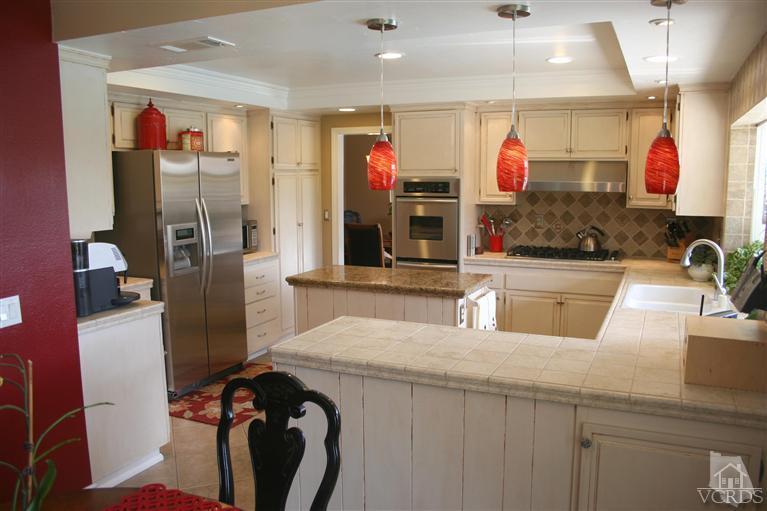 4218 Roxbury Street Simi Valley, CA 93063 - Photo 7 of 30 a kitchen with stainless steel appliances kitchen island granite countertop a sink and a refrigerator