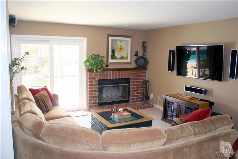4218 Roxbury Street Simi Valley, CA 93063 - Photo 9 of 30 a living room with furniture a flat screen tv and a fireplace