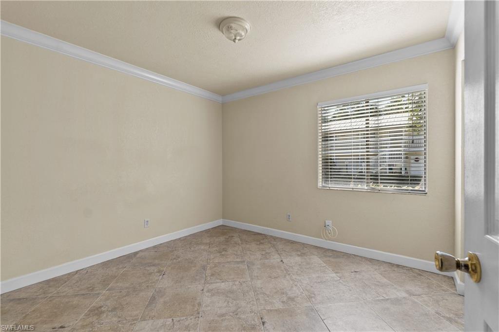 4615 Bayshore Drive, Unit E4 Naples, FL 34112 - Photo 11 of 30 a view of an empty room with a window