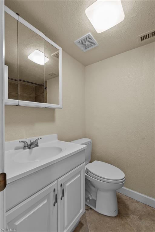 4615 Bayshore Drive, Unit E4 Naples, FL 34112 - Photo 14 of 30 a bathroom with a sink a toilet and mirror