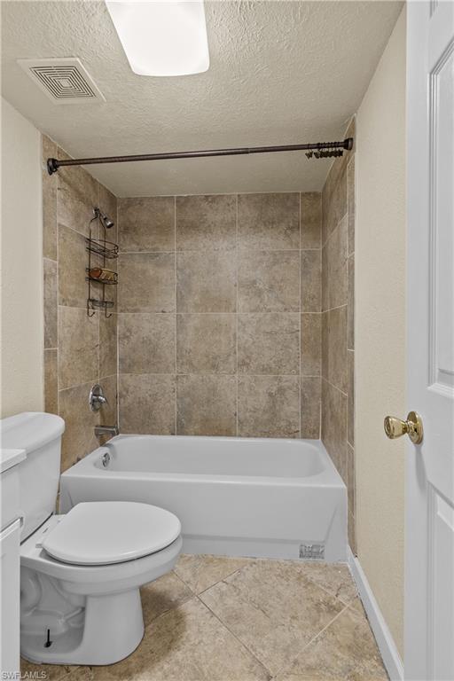 4615 Bayshore Drive, Unit E4 Naples, FL 34112 - Photo 17 of 30 a bathroom with a toilet and a shower