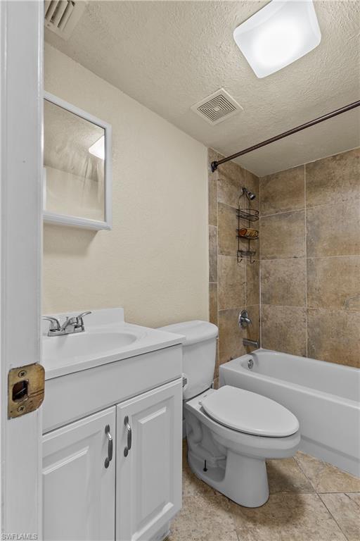 4615 Bayshore Drive, Unit E4 Naples, FL 34112 - Photo 18 of 30 a bathroom with a sink a toilet and shower