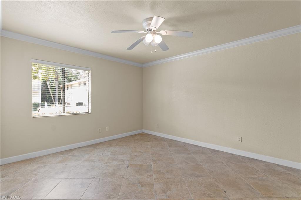 4615 Bayshore Drive, Unit E4 Naples, FL 34112 - Photo 20 of 30 an empty room with windows and fan